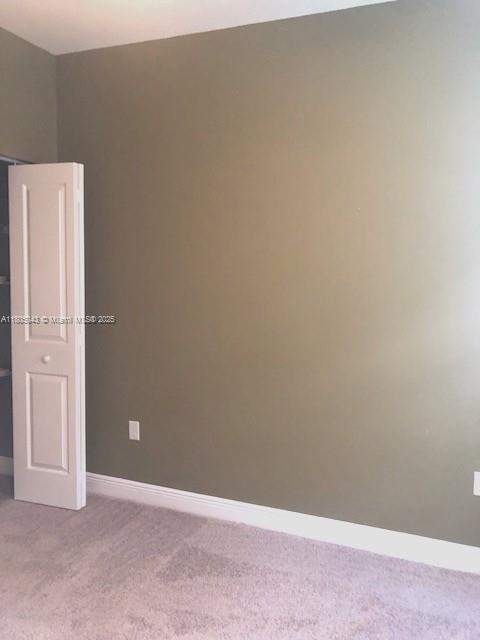 3311 NW 125th Ln, Sunrise, FL 33323 - carpeted empty room with baseboards