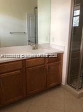 3311 NW 125th Ln, Sunrise, FL 33323 - bathroom with vanity, tile patterned floors, and a shower stall