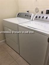 3311 NW 125th Ln, Sunrise, FL 33323 - laundry area with independent washer and dryer, tile patterned flooring, and baseboards
