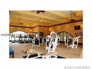 3311 NW 125th Ln, Sunrise, FL 33323 - exercise room featuring beamed ceiling and a ceiling fan