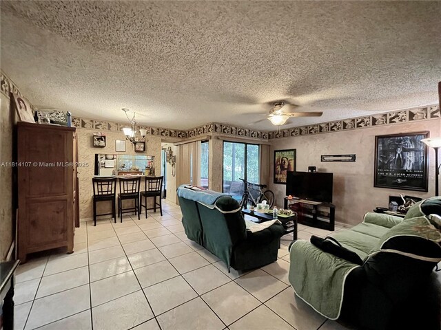 1150 N Liberty Ave Unit K, Homestead, FL 33034 - living area with a textured ceiling, light tile patterned flooring, a chandelier, and a ceiling fan
