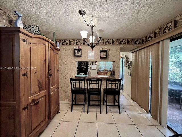 1150 N Liberty Ave Unit K, Homestead, FL 33034 - dining area with a chandelier, a textured ceiling, and light tile patterned flooring