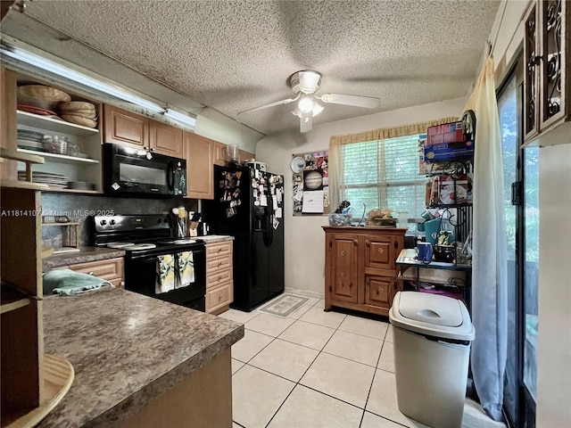 1150 N Liberty Ave Unit K, Homestead, FL 33034 - kitchen with black appliances, ceiling fan, dark countertops, light tile patterned flooring, and a textured ceiling