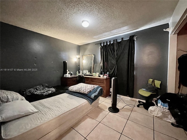 1150 N Liberty Ave Unit K, Homestead, FL 33034 - bedroom featuring a textured ceiling and light tile patterned flooring