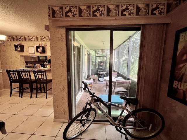 1150 N Liberty Ave Unit K, Homestead, FL 33034 - dining space featuring light tile patterned floors, a textured ceiling, and baseboards