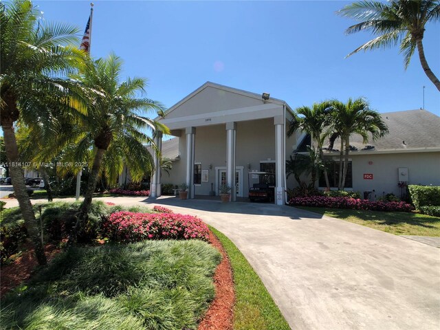 1150 N Liberty Ave Unit K, Homestead, FL 33034 - neoclassical / greek revival house featuring concrete driveway and stucco siding