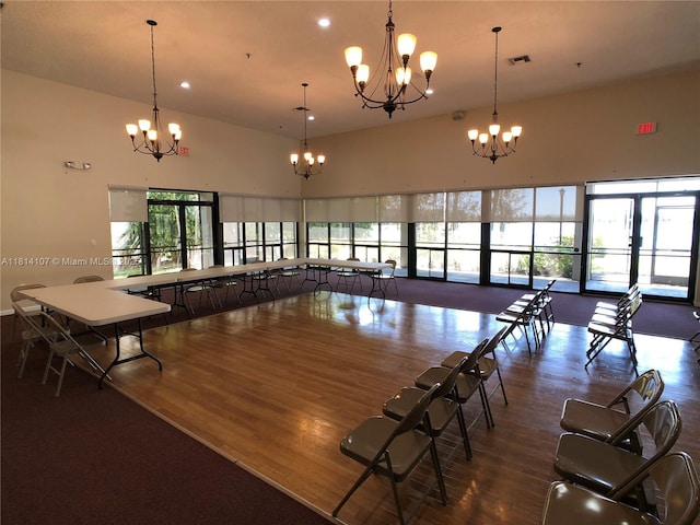 1150 N Liberty Ave Unit K, Homestead, FL 33034 - dining area featuring a chandelier, wood finished floors, a towering ceiling, and recessed lighting