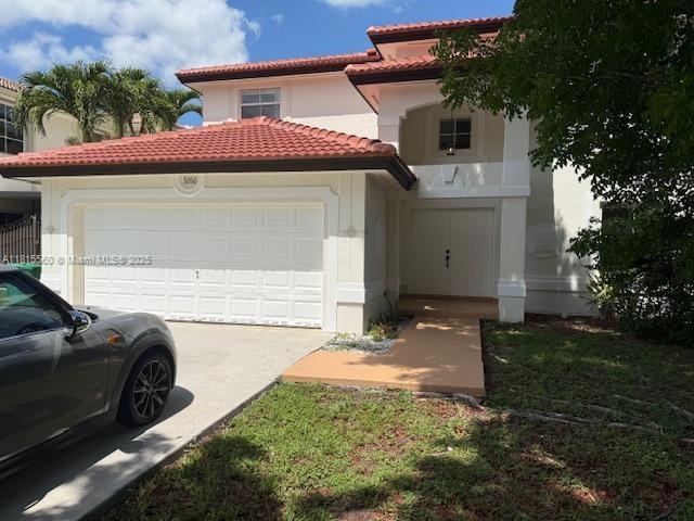 3260 SW 149th Ave, Miami, FL 33185 - mediterranean / spanish house featuring a garage, a tile roof, concrete driveway, and stucco siding