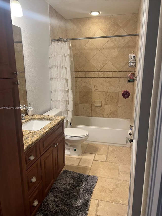 416 N Deane Duff Ave, Clewiston, FL 33440 - bathroom with shower / bath combo with shower curtain, vanity, stone tile floors, and toilet