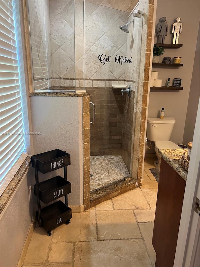 416 N Deane Duff Ave, Clewiston, FL 33440 - bathroom featuring stone tile flooring, toilet, a shower stall, vanity, and baseboards