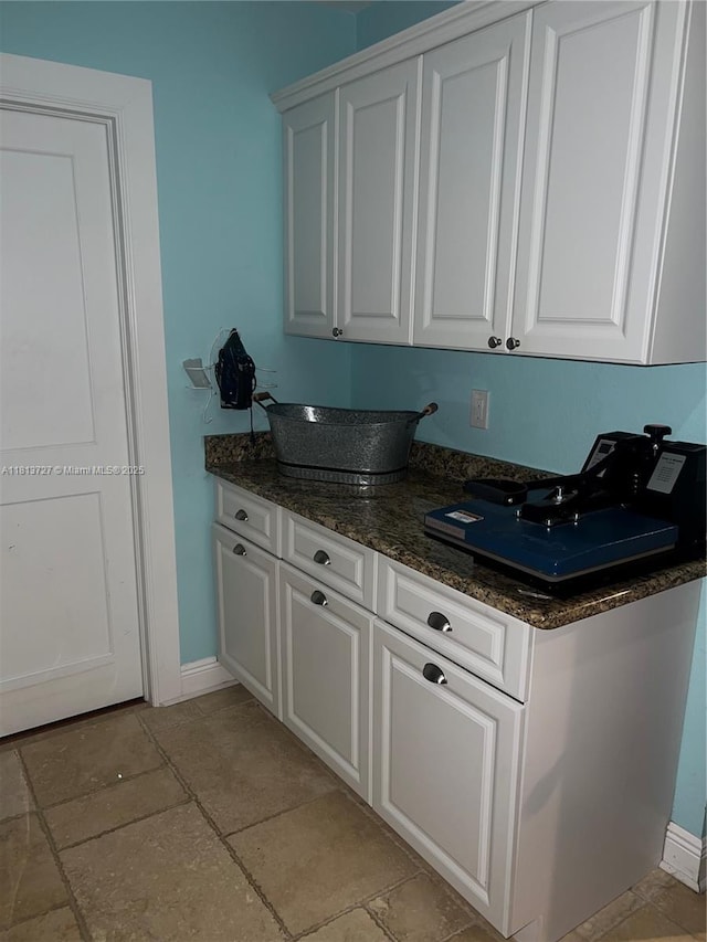 416 N Deane Duff Ave, Clewiston, FL 33440 - kitchen featuring baseboards, white cabinetry, and dark stone counters