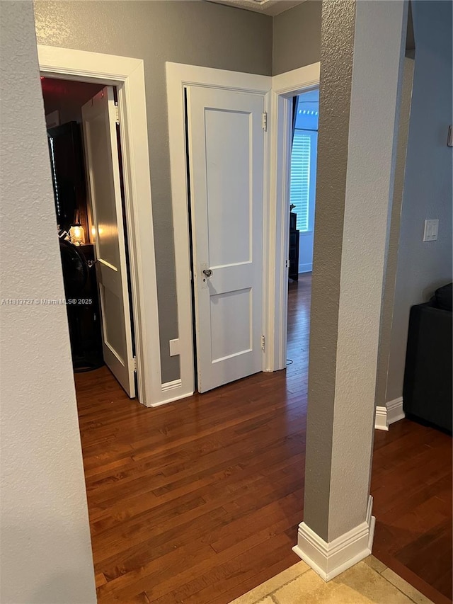 416 N Deane Duff Ave, Clewiston, FL 33440 - hall featuring wood finished floors, a textured wall, and baseboards