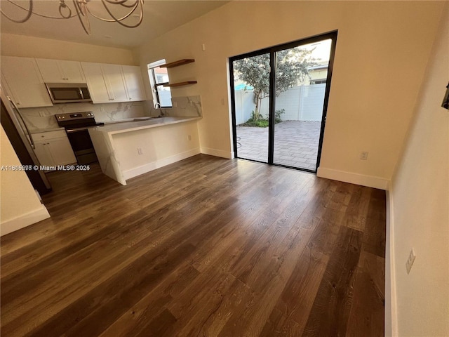 10617 W 33rd Way, Hialeah, FL 33018 - kitchen with appliances with stainless steel finishes, white cabinetry, light countertops, dark wood-style flooring, and a peninsula