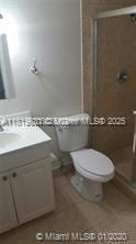 8045 SW 107th Ave Unit 323, Miami, FL 33173 - full bathroom with vanity, a stall shower, and toilet