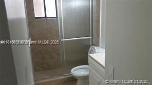 8045 SW 107th Ave Unit 323, Miami, FL 33173 - bathroom with toilet, a stall shower, and vanity