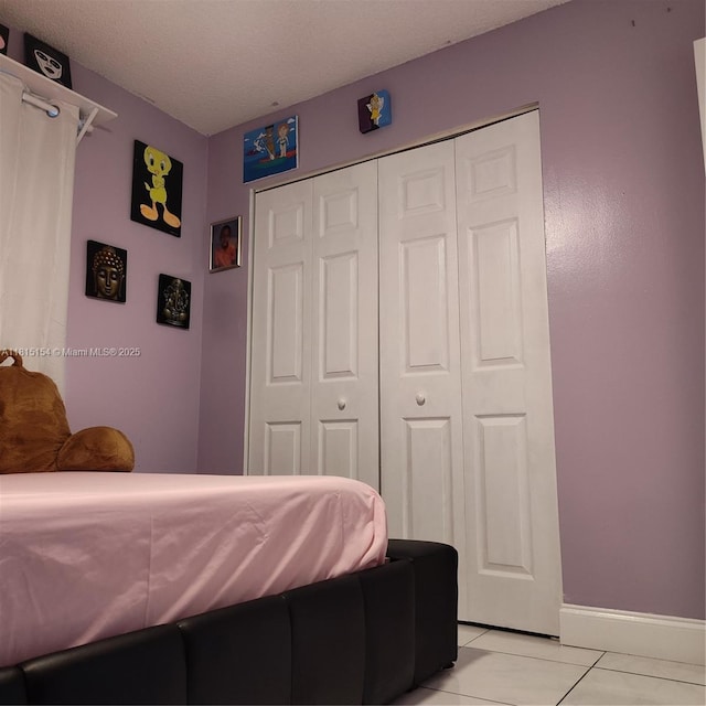 7486 SW 162nd Ct, Miami, FL 33193 - bedroom featuring a closet, baseboards, and light tile patterned floors