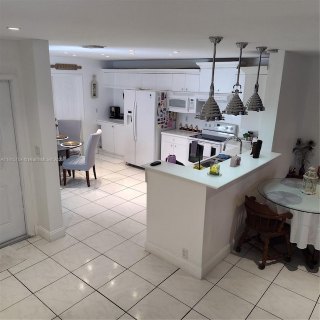 7486 SW 162nd Ct, Miami, FL 33193 - kitchen featuring white appliances, a peninsula, white cabinetry, light countertops, and recessed lighting