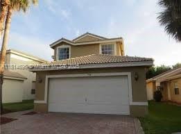 16362 SW 23rd St, Miramar, FL 33027 - view of front of property featuring driveway, stucco siding, a garage, and a tiled roof