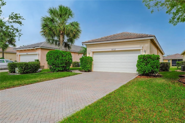 9722 SW Glenbrook Dr, Port St Lucie, FL 34987 - single story home featuring stucco siding, decorative driveway, a front lawn, and a tile roof