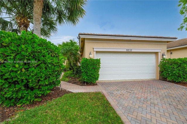 9722 SW Glenbrook Dr, Port St Lucie, FL 34987 - garage featuring decorative driveway