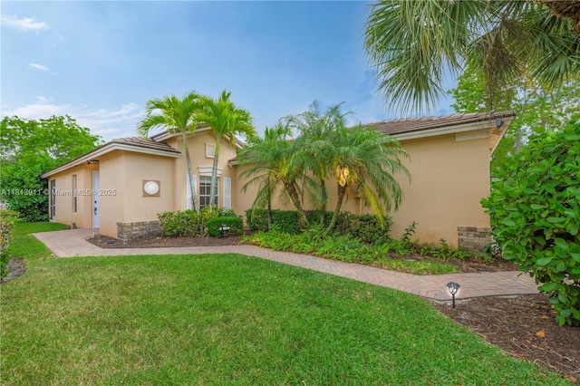 9722 SW Glenbrook Dr, Port St Lucie, FL 34987 - mediterranean / spanish-style house with stucco siding and a front lawn