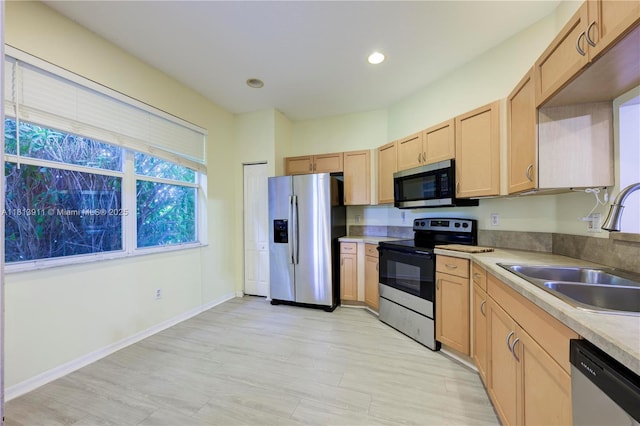 9722 SW Glenbrook Dr, Port St Lucie, FL 34987 - kitchen featuring stainless steel appliances, a sink, light brown cabinetry, light countertops, and recessed lighting