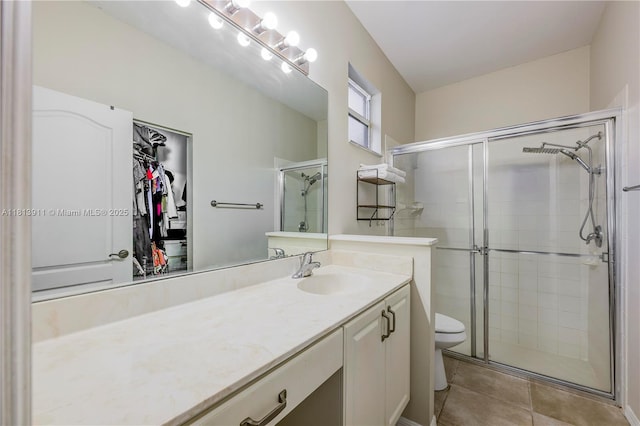 9722 SW Glenbrook Dr, Port St Lucie, FL 34987 - full bath with a shower stall, vanity, tile patterned flooring, toilet, and a walk in closet
