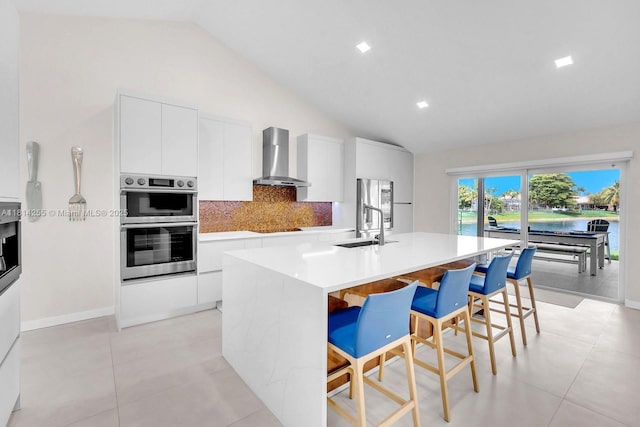 1240 NW 161st Ave, Pembroke Pines, FL 33028 - kitchen with wall chimney exhaust hood, modern cabinets, a sink, backsplash, and high vaulted ceiling
