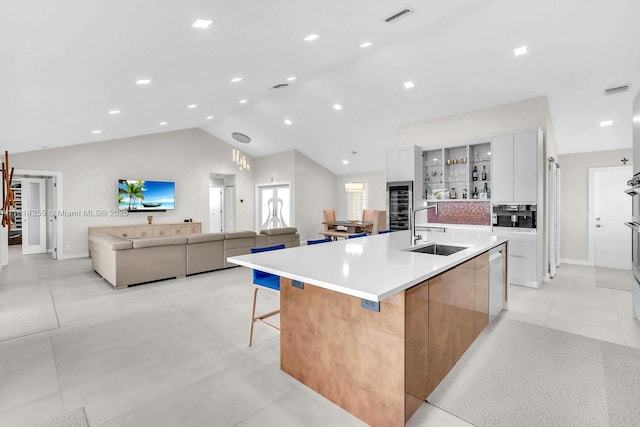 1240 NW 161st Ave, Pembroke Pines, FL 33028 - kitchen with modern cabinets, a sink, vaulted ceiling, a large island, and a breakfast bar