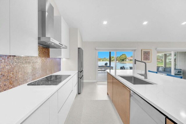 1240 NW 161st Ave, Pembroke Pines, FL 33028 - kitchen with wall chimney range hood, modern cabinets, dishwasher, stainless steel fridge, and black electric cooktop