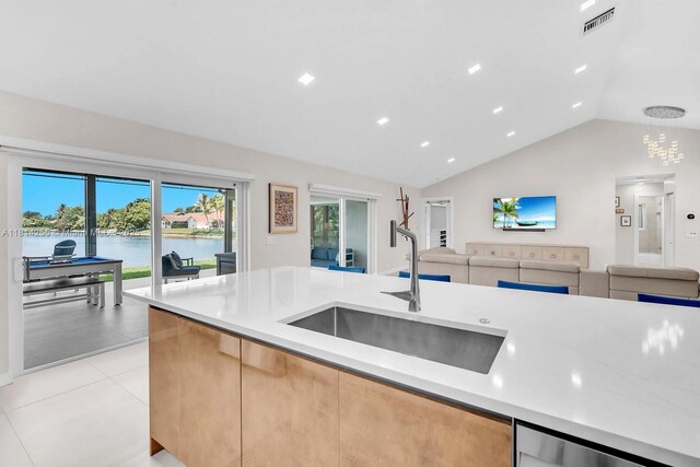 1240 NW 161st Ave, Pembroke Pines, FL 33028 - kitchen with a sink, open floor plan, vaulted ceiling, light tile patterned floors, and a water view