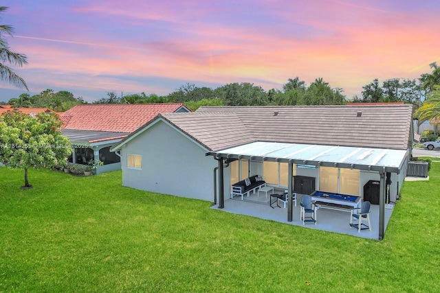 1240 NW 161st Ave, Pembroke Pines, FL 33028 - rear view of property featuring a lawn, a patio, and stucco siding