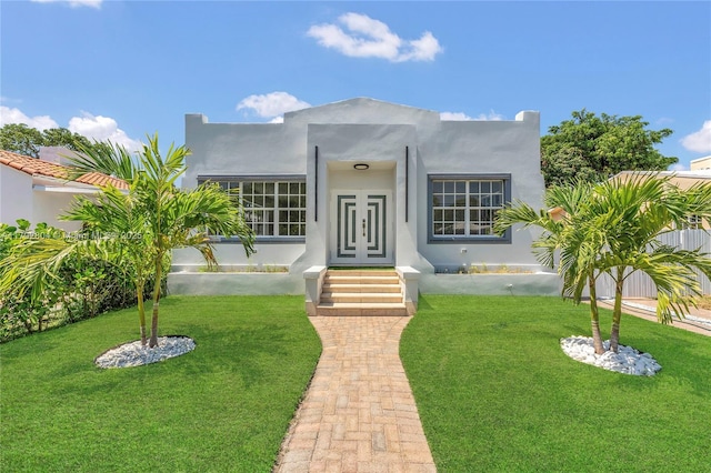 2357 SW 11th Ter, Miami, FL 33135 - art deco inspired home featuring a front lawn and stucco siding