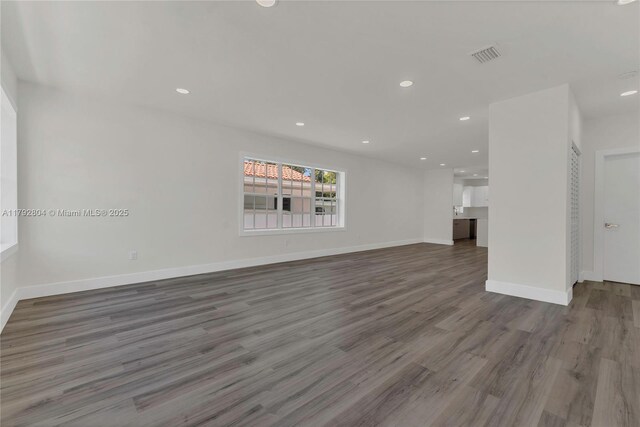 2357 SW 11th Ter, Miami, FL 33135 - unfurnished living room featuring wood finished floors, recessed lighting, and baseboards