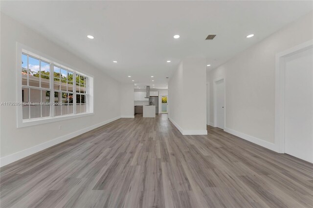 2357 SW 11th Ter, Miami, FL 33135 - unfurnished living room featuring light wood-type flooring, recessed lighting, and baseboards