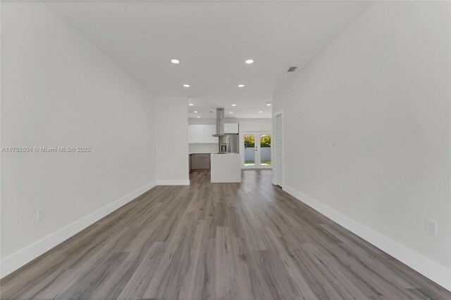 2357 SW 11th Ter, Miami, FL 33135 - unfurnished living room featuring french doors, recessed lighting, wood finished floors, and baseboards