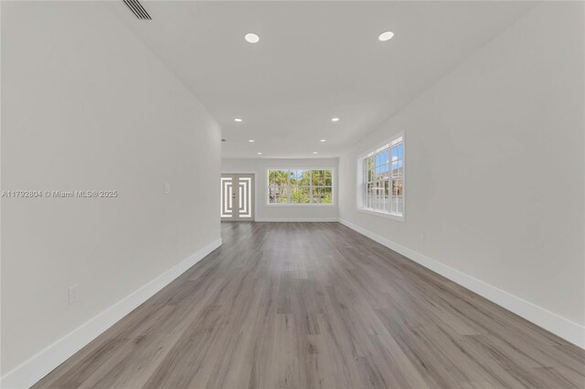 2357 SW 11th Ter, Miami, FL 33135 - unfurnished living room with baseboards, recessed lighting, and wood finished floors