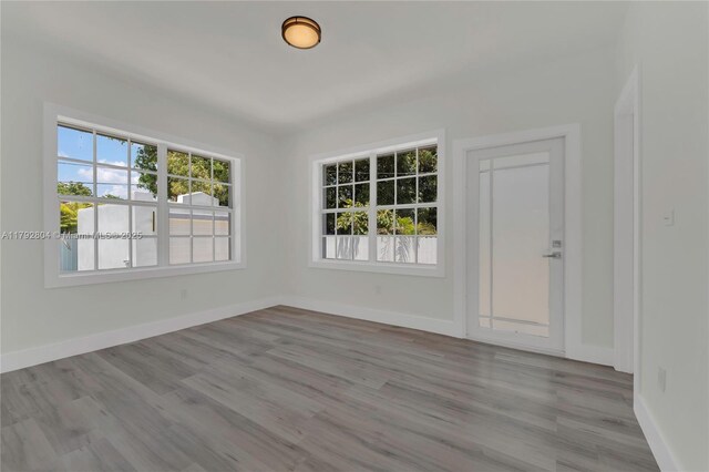 2357 SW 11th Ter, Miami, FL 33135 - spare room featuring healthy amount of natural light, wood finished floors, and baseboards