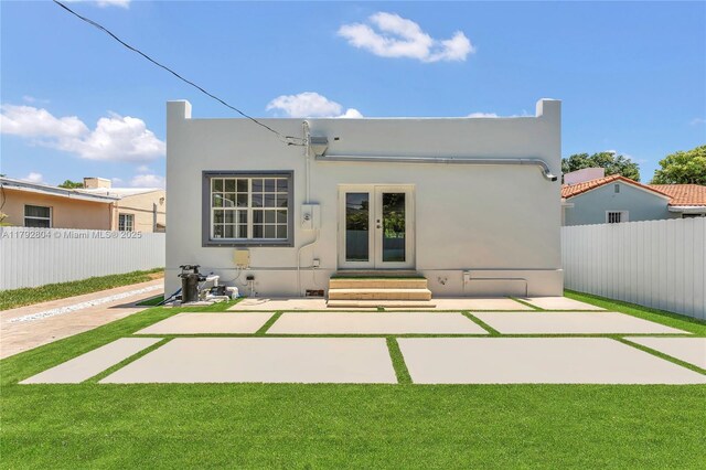 2357 SW 11th Ter, Miami, FL 33135 - back of house with entry steps, french doors, a patio, and stucco siding