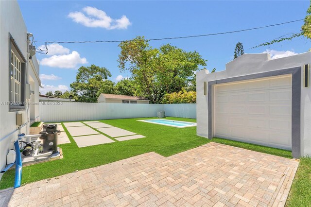 2357 SW 11th Ter, Miami, FL 33135 - view of yard featuring a garage and a patio area