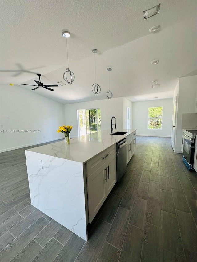 8036 104th Ct, Vero Beach, FL 32967 - kitchen featuring appliances with stainless steel finishes, wood tiled floors, white cabinetry, pendant lighting, and a kitchen island with sink