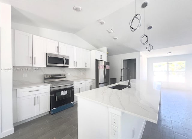 8036 104th Ct, Vero Beach, FL 32967 - kitchen with appliances with stainless steel finishes, lofted ceiling, wood finish floors, and white cabinets