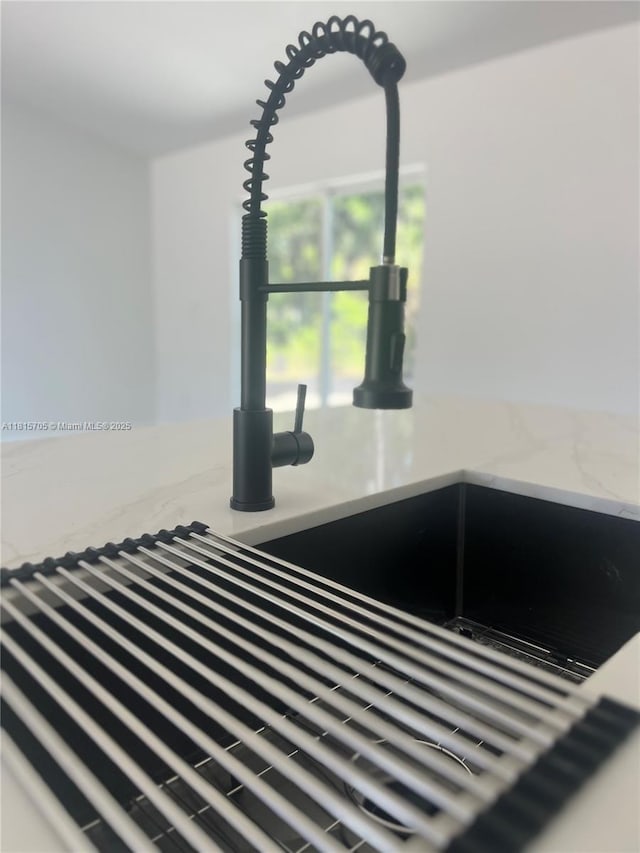 8036 104th Ct, Vero Beach, FL 32967 - kitchen view of a sink and light stone counters