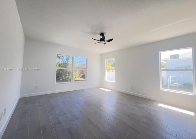 8036 104th Ct, Vero Beach, FL 32967 - spare room featuring a ceiling fan and dark wood finished floors