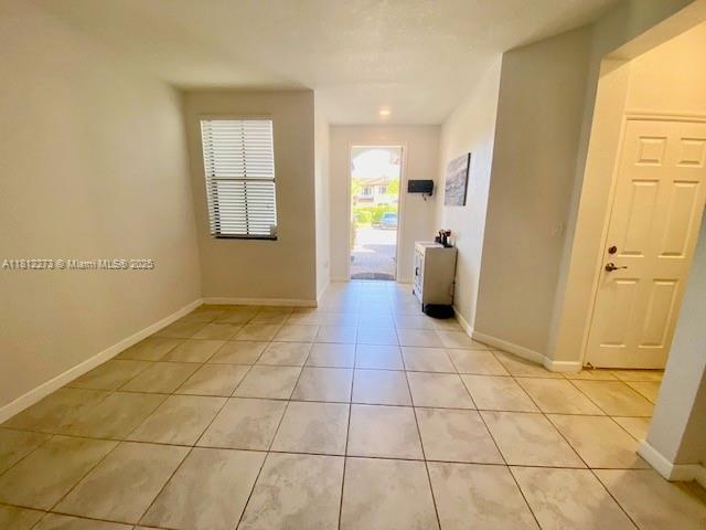 6489 N Anise Ct, Davie, FL 33314 - spare room featuring light tile patterned floors and baseboards