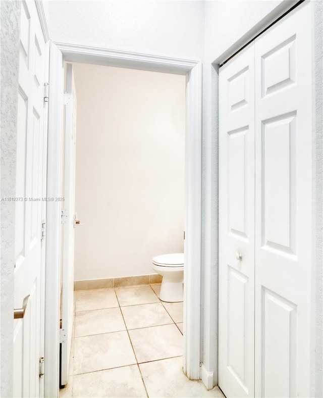 6489 N Anise Ct, Davie, FL 33314 - bathroom featuring toilet, a closet, tile patterned flooring, and baseboards