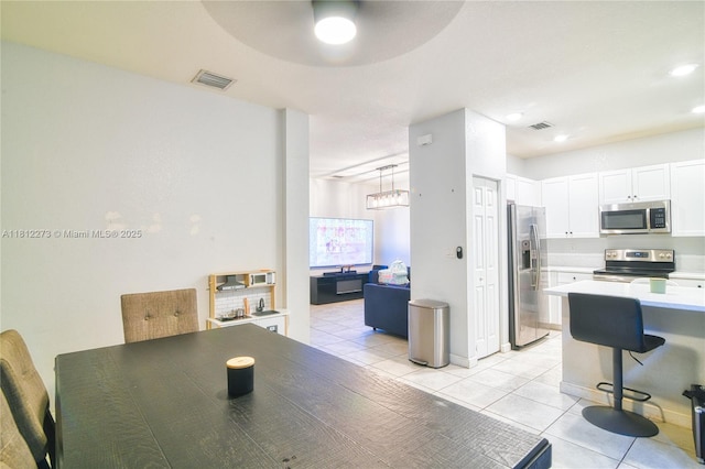 6489 N Anise Ct, Davie, FL 33314 - dining space featuring light tile patterned floors, a ceiling fan, a chandelier, and recessed lighting