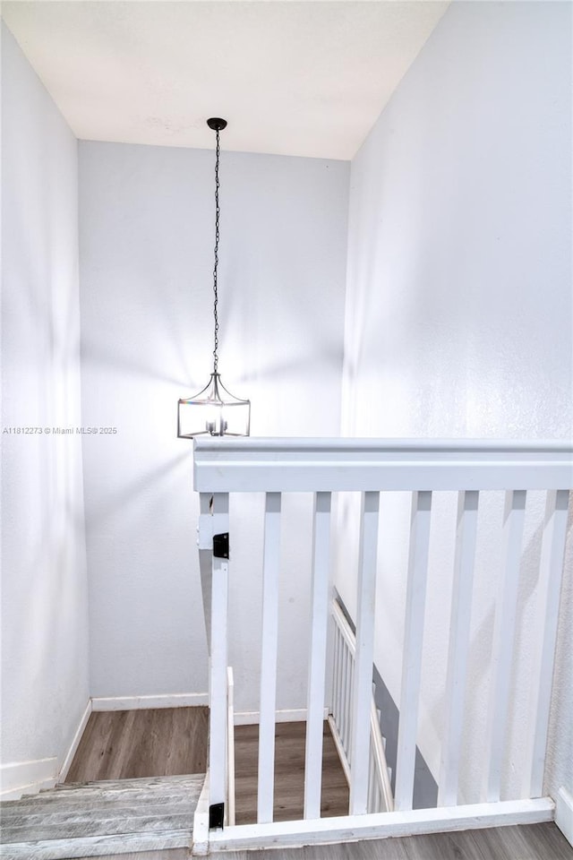 6489 N Anise Ct, Davie, FL 33314 - stairway with wood finished floors, a chandelier, and baseboards