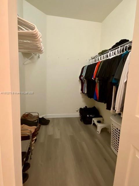 6489 N Anise Ct, Davie, FL 33314 - spacious closet featuring wood finished floors