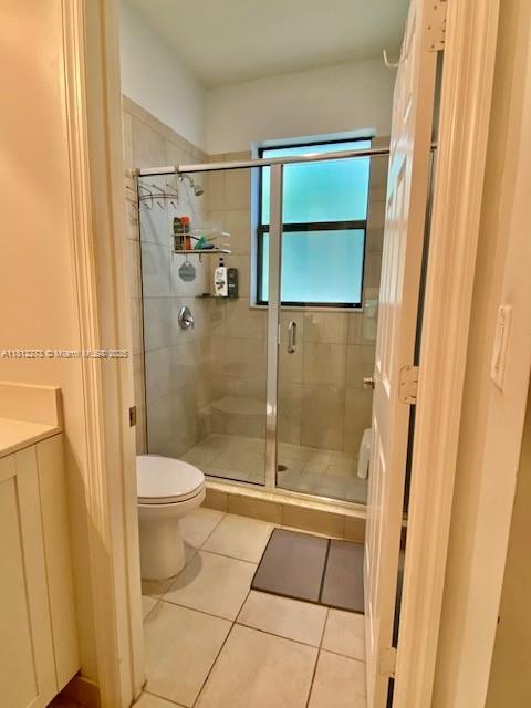 6489 N Anise Ct, Davie, FL 33314 - bathroom featuring a stall shower, tile patterned floors, and vanity